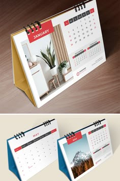 two desk calendars sitting on top of a wooden table