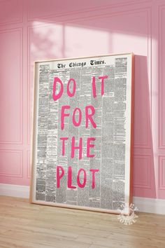 a poster with the words do it for the plot in pink on a wooden floor