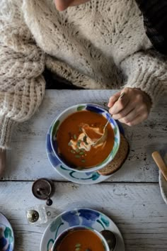 two bowls of soup are sitting on a table