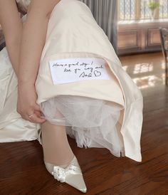 a bride's wedding dress and shoes with a note on the bottom that says, there is only one day i will take you