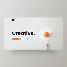 a person holding an egg on top of a white board with the word creative written below it