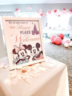 there is a sign that says happy place welcome to mickey and minnie on the table