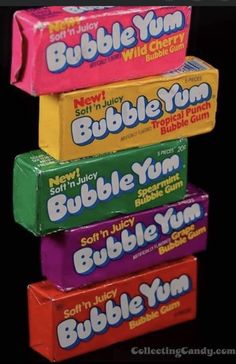 three bars of bubble gum stacked on top of each other in different colors and flavors