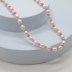 you'll be sure to turn heads in our Summer In The Hamptons Necklace. make any outfit pop with our combination classic pearls and alternating colorful beads. pair with our Summer Days Necklace (heart) for the perfect summer look. freshwater pearls, 8mm x 6mm colored beads, 2mm 18k triple gold plated over brass 13" + 3" extender shown with our Summer Days Necklace (heart) Trendy White Pearl Necklace With Heart Beads, Pink Pearl Necklace With Heart Beads, Adjustable Pearl Necklace With Heart And Round Beads, Adjustable Pearl Necklace With Heart Beads, Pearl Necklace With Heart Shaped Beads And Round Beads, Pearl Necklace With Heart And Round Beads, Summer In The Hamptons, Brazilian Gold, Synthetic Diamond