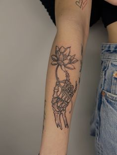 a woman's arm with a tattoo on it and a flower in the middle