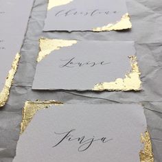 three pieces of paper with gold foil on them and the words love are written in black ink