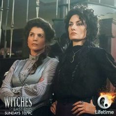 two women standing next to each other in front of a building with the words witches on it