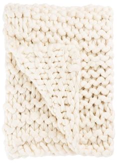 a white knitted blanket folded on top of each other, with two rows of yarn in the middle