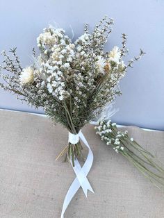 a bouquet of flowers tied to a white ribbon