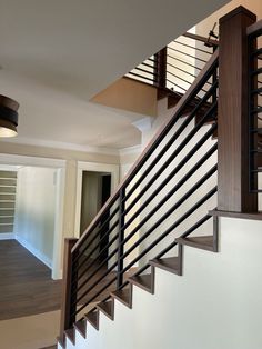 a stair case in a house with wood and metal railings