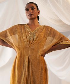 Editor's Note Drape yourself in the rich elegance of our mustard tissue kaftan, adorned with exquisite gota patti work on the neckline and side seam. This ensemble is a perfect blend of comfort and style, making it a splendid choice for special occasions where you want to make a fashionable statement with ease. Fabric: Tissue and cotton Color: Mustard Component: Kaftan and slip Occasion: Festive Note: Product colour may slightly vary due to photographic lighting sources Care: Dry clean only Abou Gota Patti Embroidery, Peacock Embroidery, Placement Embroidery, Gota Patti Work, Kaftan For Women, Yellow Silk, Fabric Silk