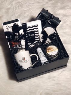 the gift box contains two mugs, an assortment of personal care items