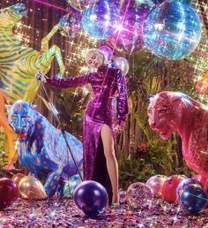 a woman in a purple dress surrounded by balloons and animals