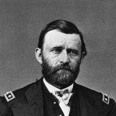 an old black and white photo of a man with a beard wearing a suit jacket