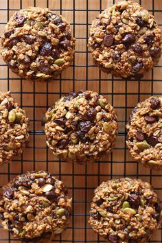 several cookies on a cooling rack with nuts and raisins in them, ready to be eaten