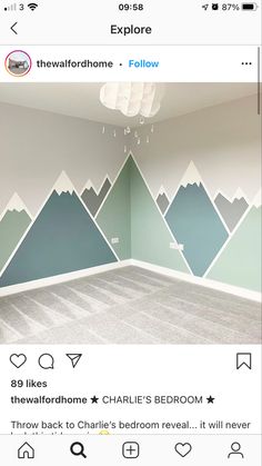 a room with mountains painted on the walls and carpeted flooring in front of it