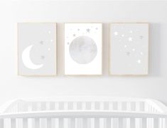 three posters on the wall above a crib in a baby's nursery room