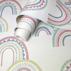 a wallpaper with rainbows and circles on it, including a roll of tape