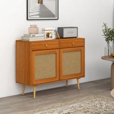 a wooden cabinet with wicker doors and drawers in a room next to a rug