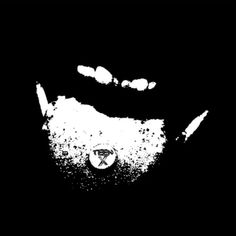 a black and white image of a man's face with his mouth open in the dark