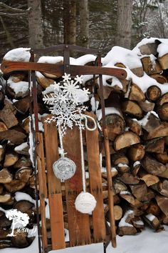 a wooden sled with snowflakes and ornaments hanging from it