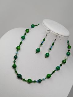 32-inch long beaded green necklace with magnetic closure. Beads are 2-15mm, glass, acrylic and porcelain strung on nylon coated wire. Earrings are 3 drop on fish hooks 22-inch long beaded necklace with lobster closure. Beads are 2-15mm, glass, acrylic and porcelain strung on nylon coated wire. Earrings are 2-inch dangles on fish hooks 22-inch faux pearl and cut glass bead necklace strung on silk cording with gold tone toggle closure. Earrings are 1.5-inch dangles on fish hooks. Green Czech Glass Necklace With Dangling Beads, Green Polished Bead Earrings, Green Earrings With Polished Round Beads, Green Gemstone Beads Jewelry In Czech Glass, Green Single Strand Czech Glass Necklace, Single Strand Green Czech Glass Beads, Green Single Strand Necklace Made Of Czech Glass, Green Czech Glass Jewelry With Gemstone Beads, Green Czech Glass Beaded Necklace With Dangling Beads