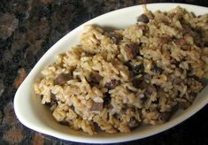 a white bowl filled with rice and meat