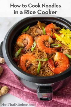 a slow cooker with noodles and shrimp in it, on top of a pink towel