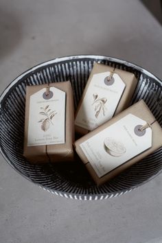 three brown boxes with tags are in a bowl