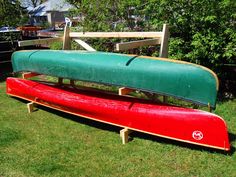 two canoes sitting on top of each other in the grass