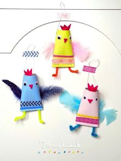 three colorful paper birds hanging from strings