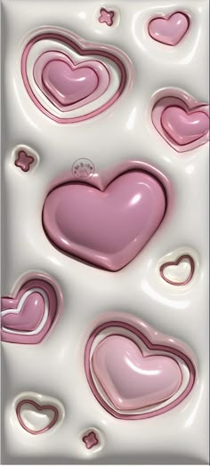 some pink hearts are in the middle of white and pink liquid with bubbles on it