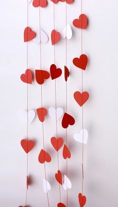 some red and white hearts hanging from strings