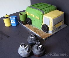 there is a cake that looks like a truck and some shoes on the table next to it