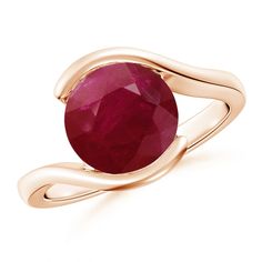 a gold ring with a red stone in the center and two curved bands around it