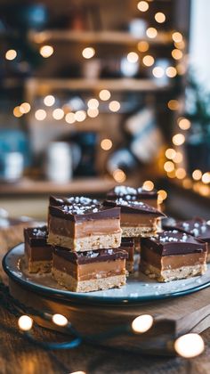 several pieces of cake sitting on top of a plate with lights in the back ground