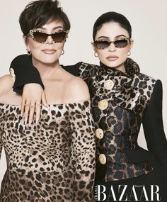 two women in animal print outfits posing for a magazine cover with their arms around each other