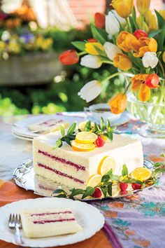 a table topped with cakes and desserts covered in frosting