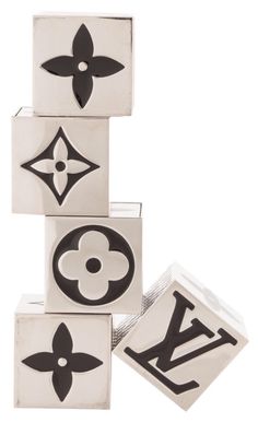 four blocks with black and white designs on them, all stacked up in the shape of letters