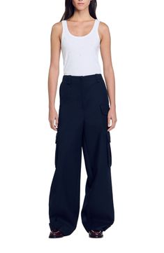 Wide-leg cargo trousers with multiple side pockets, belt loops and ironed creases.  These trousers match the jacket Sandro Women's cargo trousers Large belt loops on waist Small flap pocket and tone-on-tone covered press studs Large topstitched pockets with flaps and tone-on-tone covered press studs on the sides Patch pockets on back Lower legs have plackets with covered press studs Topstitched tab on left side Ironed creases The model is 5'9 tall and wears a size 4 Blue Utility Cargo Pants For Work, Blue Utility Pants With Flap Pockets, Wide-leg Cargo Jeans With Multiple Pockets For Work, Workwear Cargo Jeans With Flap Pockets, Blue Cargo Pants With Patch Pockets For Work, Wide-leg Cargo Jeans With Flap Pockets For Work, Blue Cargo Pants For Work With Belt Loops, Fitted Cargo Jeans With Belt Loops For Work, Workwear Parachute Pants With Multiple Pockets