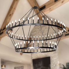 a chandelier with candles hanging from it's center in a living room