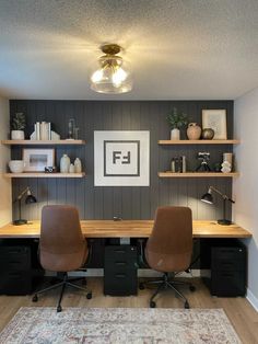 an office with two desks and shelves on the wall, along with a rug