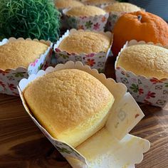 there are many different types of breads in the box on the table, and one has an orange