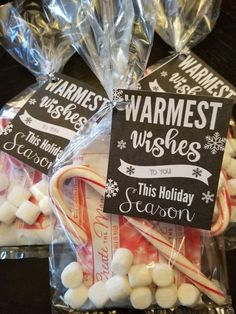 candy canes wrapped in cellophane and packaged with christmas wishes sign on them