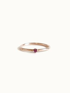 July’s birthstone - tiny ruby ring on our signature bark texture 14k yellow gold band. Dainty, delicate beauty. Perfect a lady who is not a fan of chunky gemstones, this ring won't get tangled in your clothes or hair. Match perfectly when you wear it with our dainty rings. Made of 14K yellow gold. Genuine ruby size 2 mm. Band width approximately 1.2 mm. 14k Rose Gold Birthstone Promise Ring, Stackable Ruby Ring In 14k Rose Gold, Everyday 14k Yellow Gold Ruby Ring, Dainty Ruby Ring As Birthstone, Minimalist Gold Ruby Ring, Minimalist Yellow Gold Ring With Ruby, Red 14k Gold Stackable Birthstone Rings, Dainty Stackable 14k Gold Ruby Ring, Minimalist Ruby Ring With Birthstone