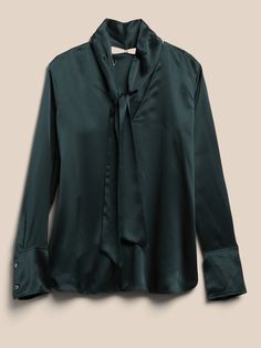 Modern and minimalist, this at-ease blouse has a removable tie-neck for even greater versatility, crafted in luxuriously soft silk charmeuse, beloved for its lustrous finish.  SEMI-FITTED: Cut for a not-too-tight, not-too-loose fit.  V-neck with remo Classic Satin Tops For Fall, Elegant Silk Tie Neck Top, Fitted Satin Tie Neck Top, Elegant Solid Color Tie Neck Tops, Elegant Satin Tie Neck Top, Elegant Satin Finish Tops For Work, Elegant Satin Finish Blouse For Work, Silk Fall Blouse, Elegant Fall Tie Neck Tops