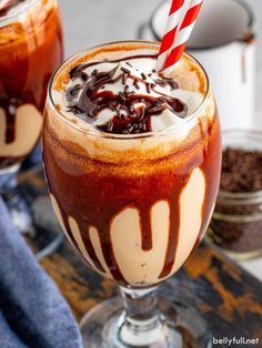 two glasses filled with ice cream, chocolate and candy canes on top of a table