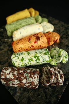 several different types of food are on a table top with black granite and green marble