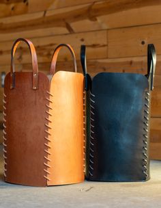 three different colored leather bags sitting next to each other