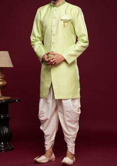 Ready-Made Sherwani With Peshawari Trouser. All Over Jacquard Brocade Style Fabric Top. Art Silk Peshawari Ready Made Trouser. Crafted in Chinese Collar Neck, and Full Sleeve. Satin Lining with Plain Work. High-Quality Matching Buttons. Please Note: The footwear shown in the picture is for presentation and photography purpose only. Color: There might be slight color variation due to lightings and flashes while photo shooting. The color may also vary because of different screen resolutions. Wash Bollywood Style Pista Green Jamawar Sets, Festive Designer Naqshi Churidar, Semi-stitched Pista Green Kurta With Naqshi, Festive Unstitched Suit With Naqshi For Navratri, Festive Unstitched Naqshi Suit For Navratri, Festive Navratri Unstitched Suit With Naqshi, Festive Naqshi Unstitched Suit For Navratri, Festive Naqshi Churidar For Festivals, Pista Green Jamawar Sets For Eid